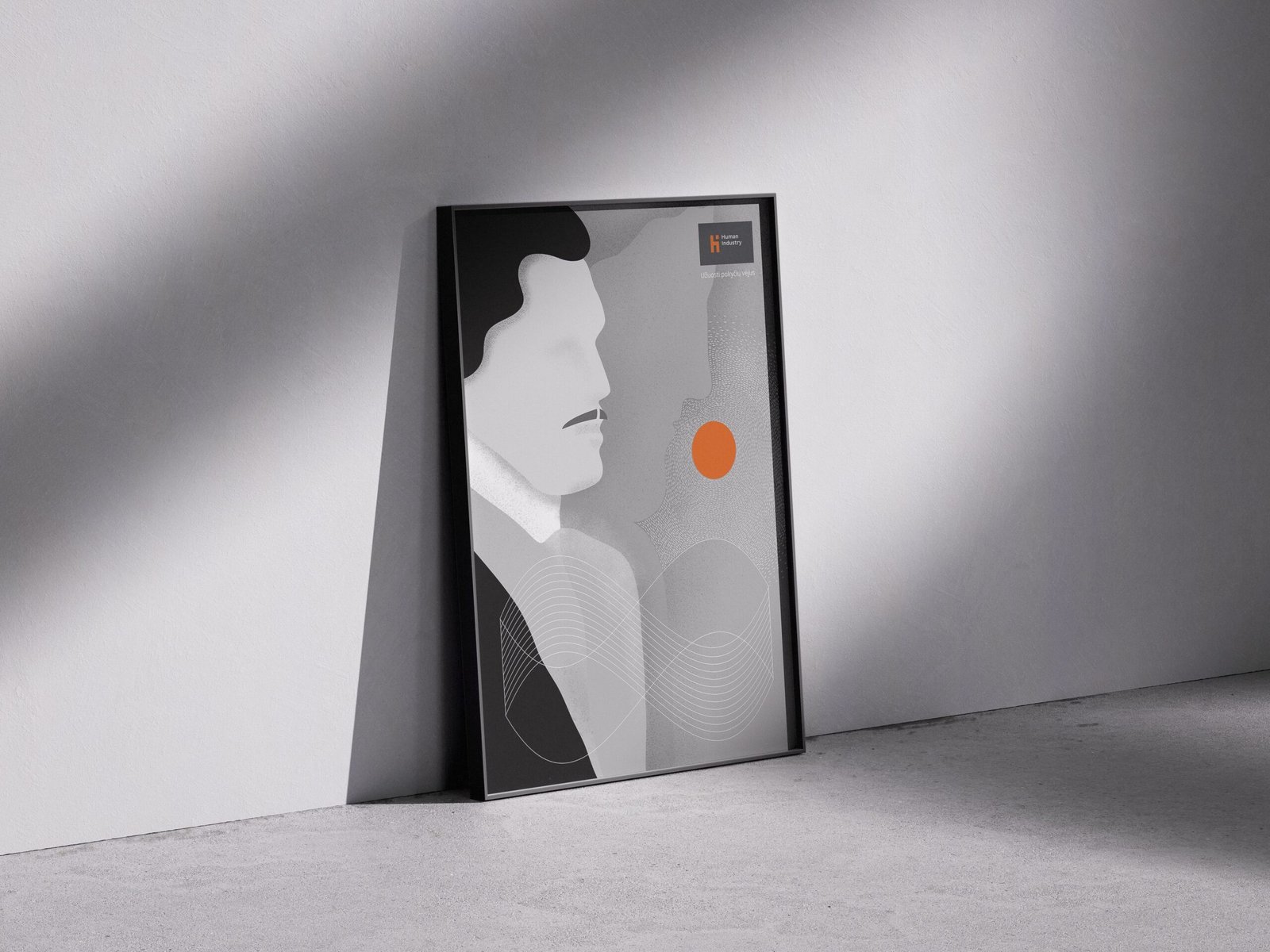 A framed Human Industry poster leans against a softly lit grey wall in a minimalist interior. The artwork shows two abstract human profiles facing each other, with a bright orange circle between them and flowing white lines across the lower half. The muted grey palette of the room makes the orange detail stand out. Poster text translates to: “Human Industry. To sense the winds of change.”