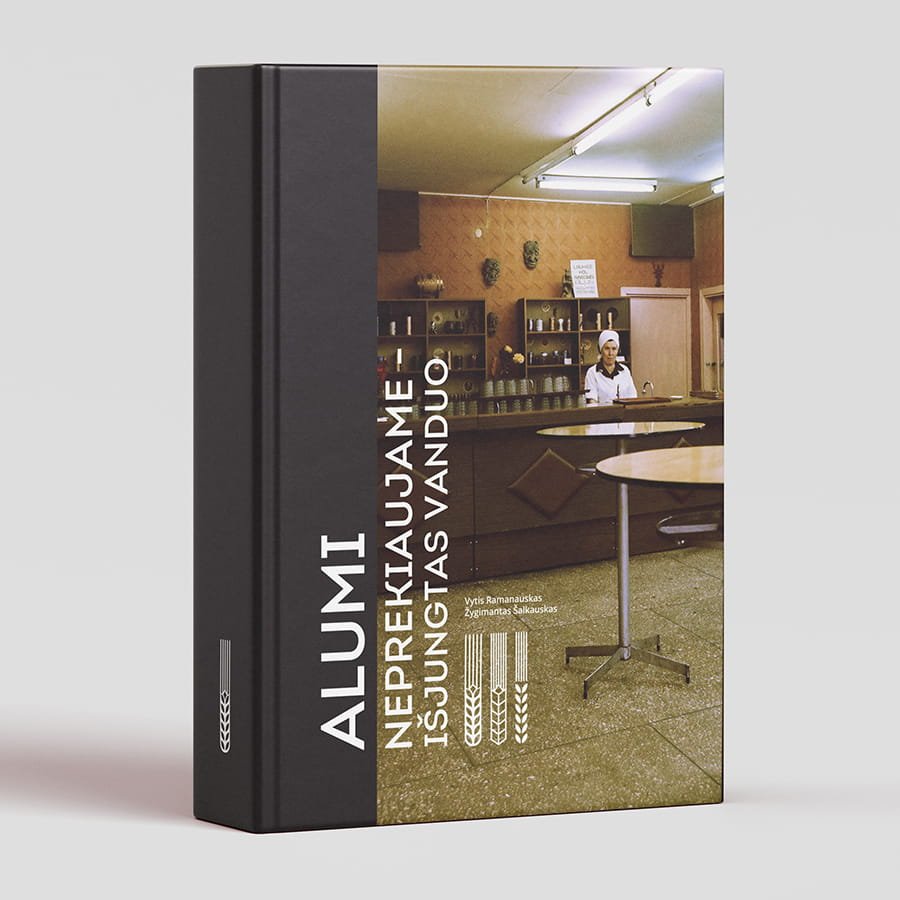 A hardcover book titled “We Don’t Sell Beer — The Water’s Been Shut Off” stands upright against a light gray background. The cover features a vintage photograph of a café interior, with a woman in a white uniform behind the counter, round tables in the foreground, shelves of cups and dishes, and fluorescent lights overhead. Authors listed on the cover: Vytis Ramanauskas and Žygimantas Šalkauskas.