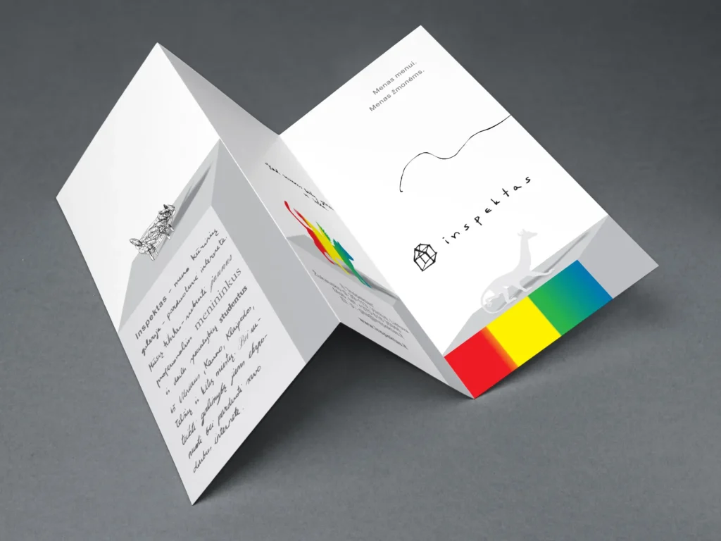 Sculptural folded white brochure for Inspektas photographed on a dark grey surface. It combines minimalist black graphics, small animal illustrations, a rainbow-colored strip, the Inspektas logo, and the headline “Art for the Art. Art for the People.” Additional Lithuanian body text is present but too small to read reliably.
