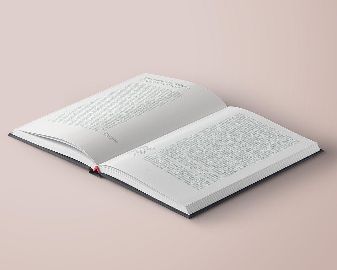Open archaeology catalogue displaying a text-focused spread with two large blocks of editorial text on white pages and a restrained, spacious layout.