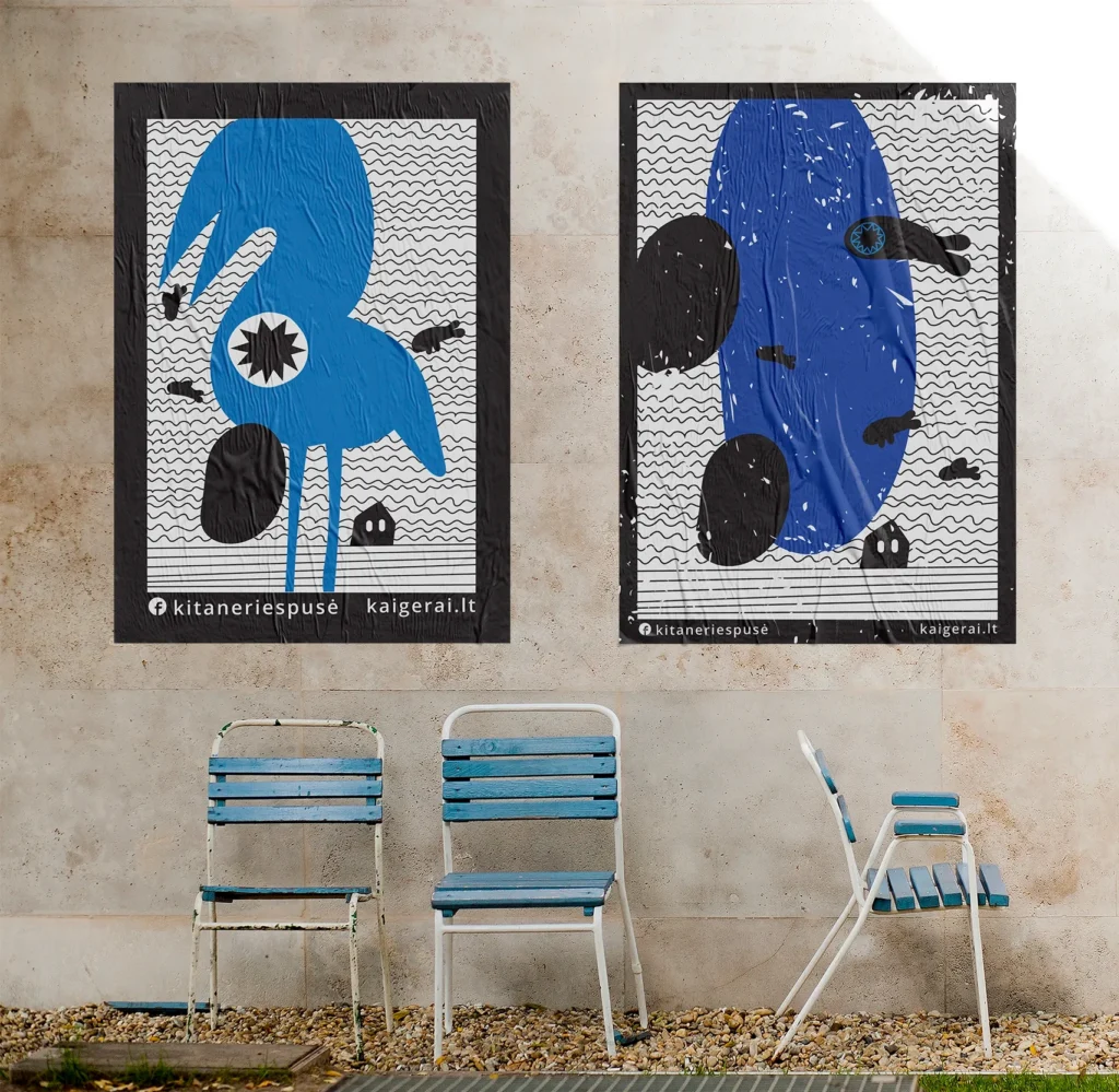 Two large blue, black and white illustrated “Kita Neries pusė” posters displayed on an outdoor wall above three mismatched blue-and-white chairs. The playful posters feature strange abstract creatures, wavy patterns and small black figures. Text at the bottom reads “kitaneriespusė” and “kaigerai.lt.”
